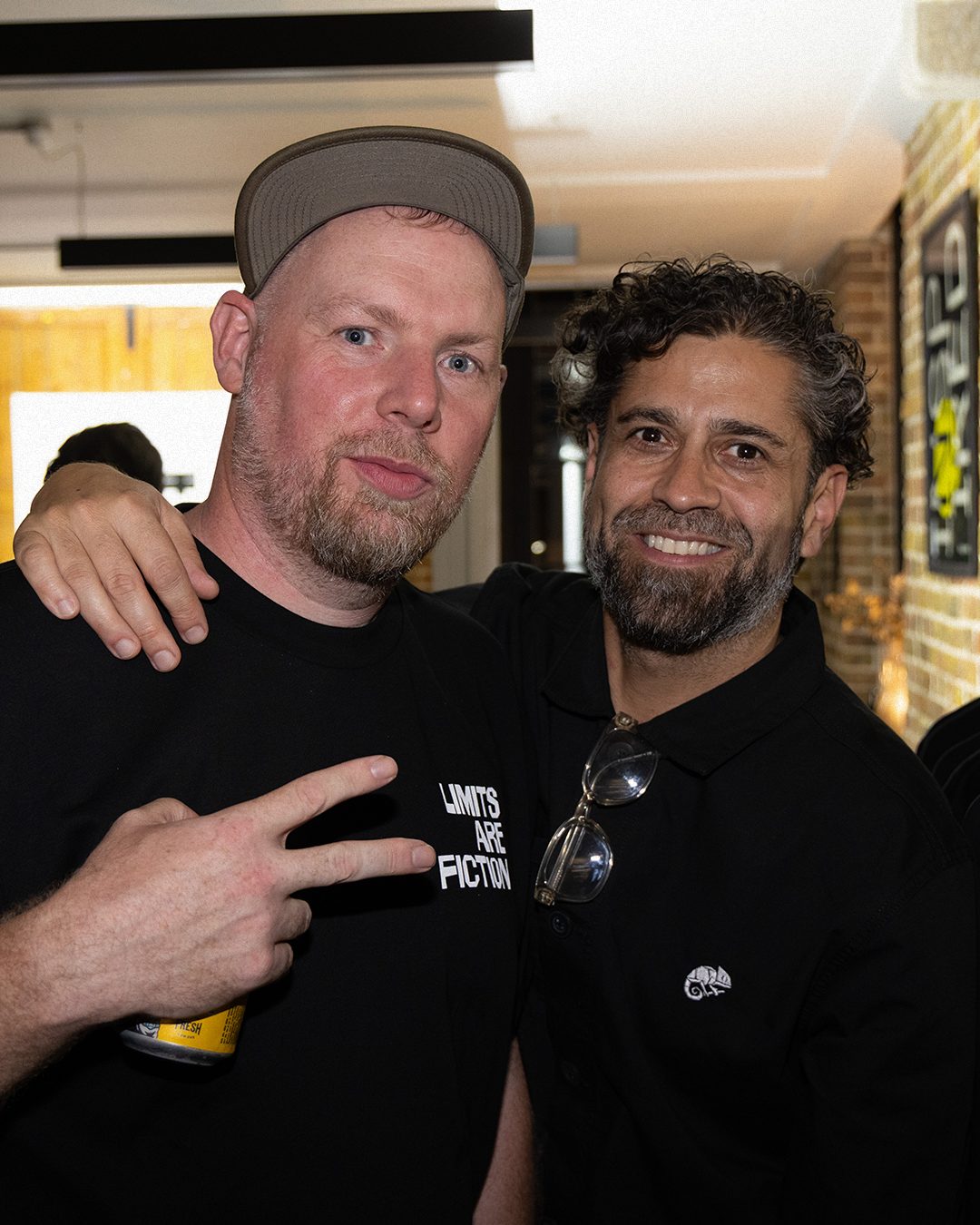 Two guests in black Limits Are Fiction tops posing together at the launch